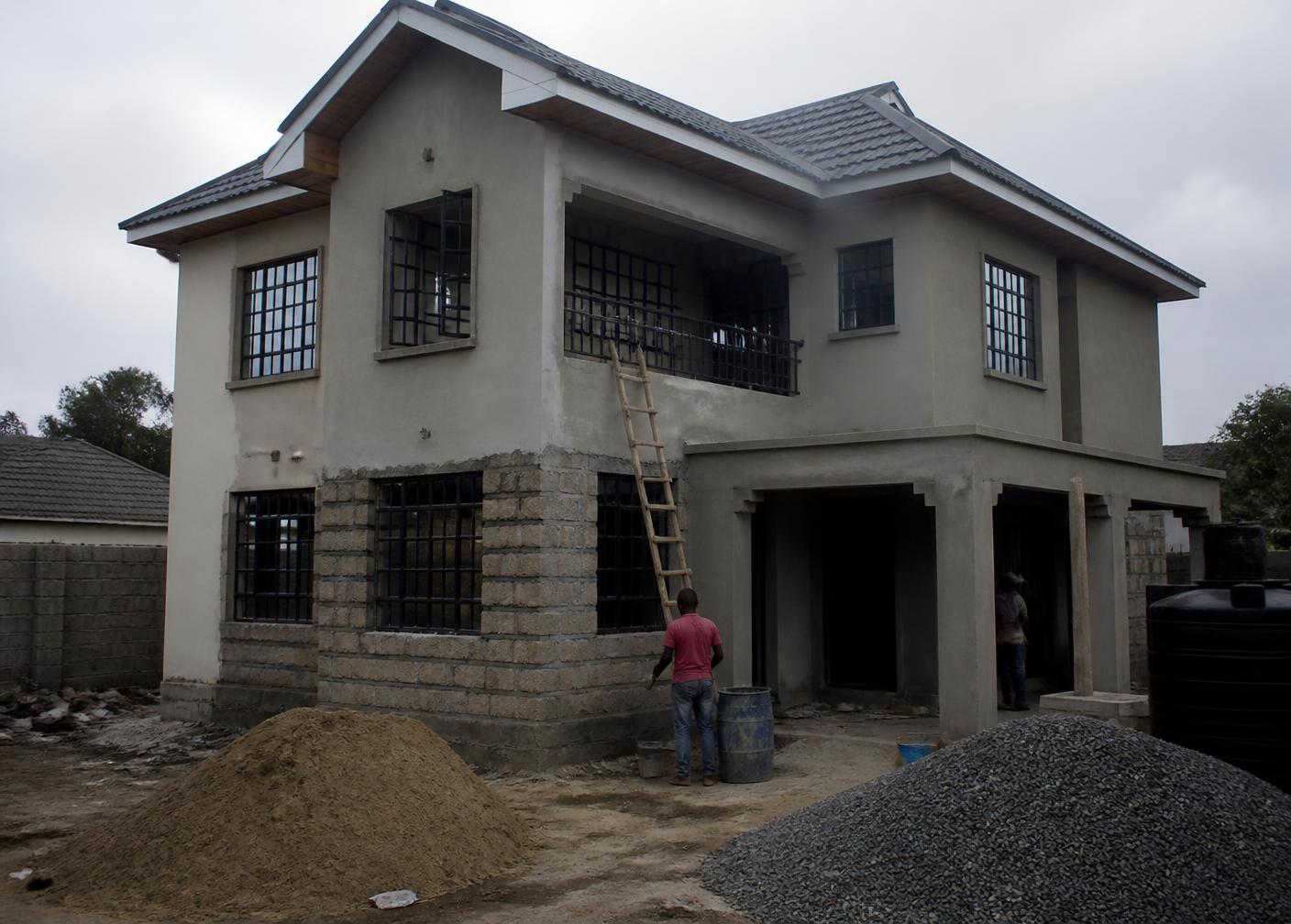 Modern modular prefabricated house with stone, concrete and timber facade